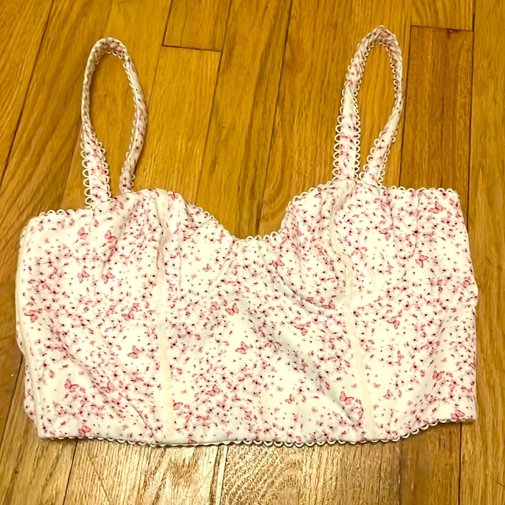 White Fox corset like top with a pink floral pattern.